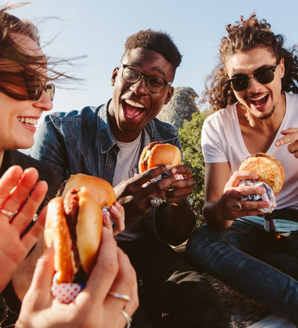 Friends having burgers on a beautiful day near The Gramercy in Manhattan, Kansas