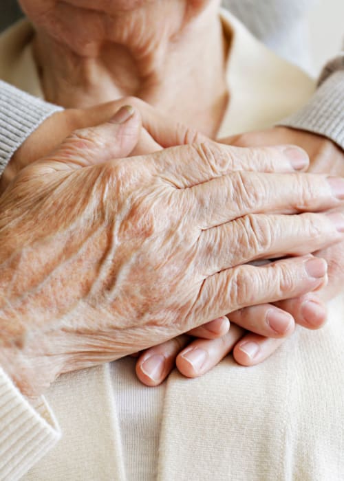 Staff member holding a resident's hands at Grand Villa of Boynton Beach in Boynton Beach, Florida