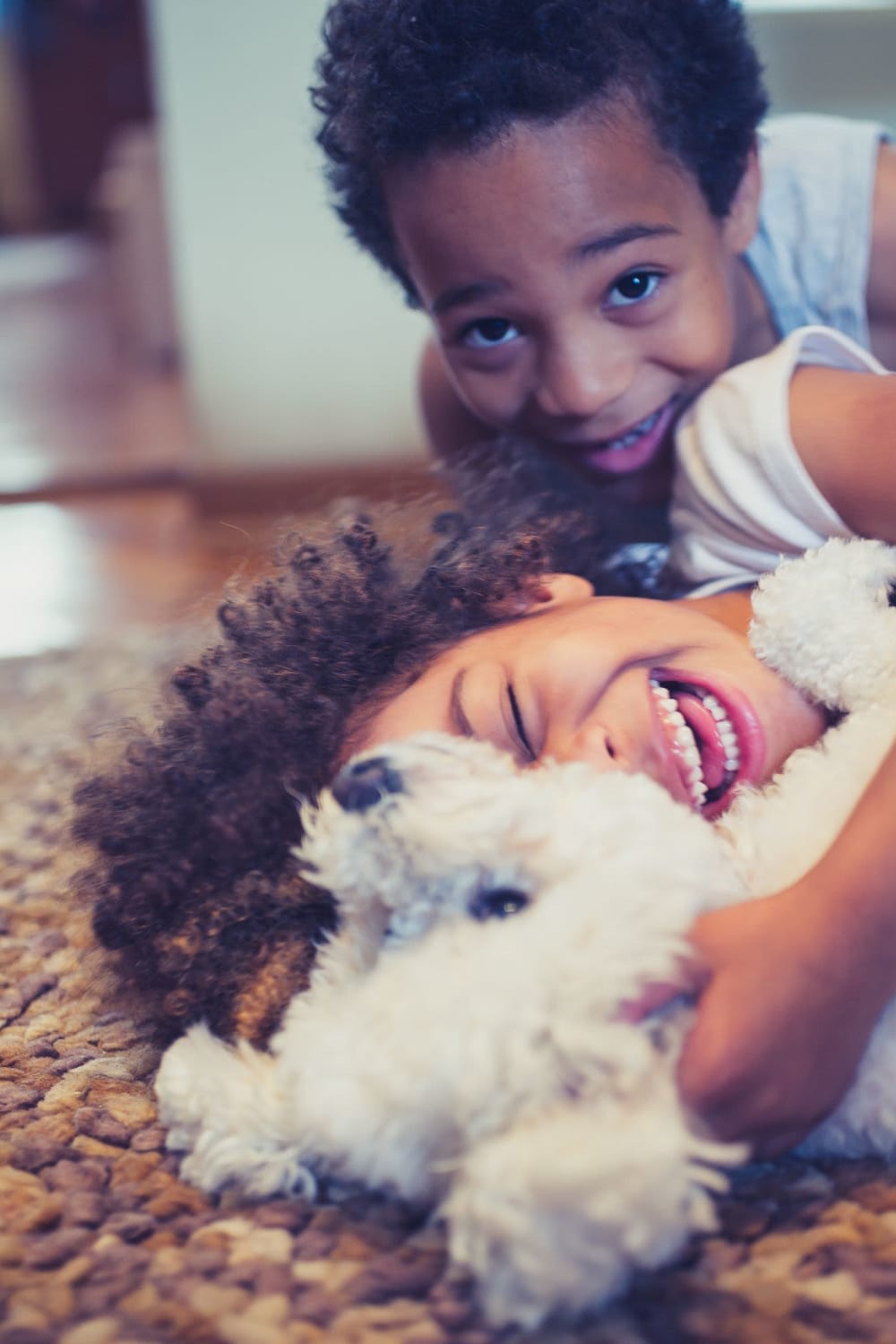 Happy dog and resident kids playing in their apartment at Corners at Holcomb Bridge in Peachtree Corners, Georgia