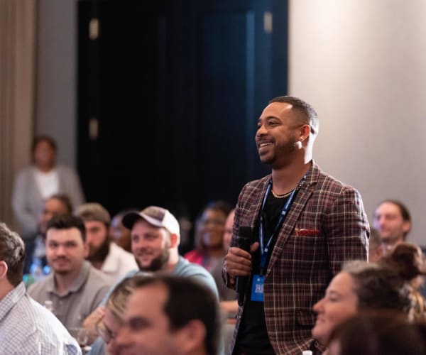 Team member asking a question at a conference at Campus Life & Style in Austin, Texas