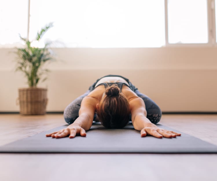 Resident doing yoga in the fitness center at Haven Warner Center in Canoga Park, California