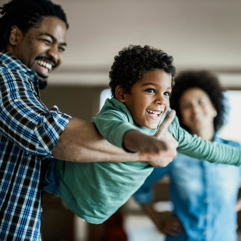 Family having fun and loving their new apartment home at Oaks Glen Lake in Minnetonka, Minnesota