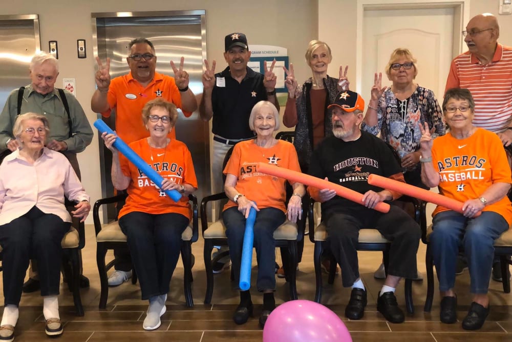 Residents and staff pose for a picture representing a baseball team at Inspired Living Sugar Land in Sugar Land, Texas