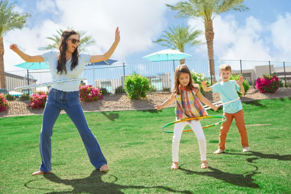 Happy family playing in the park near Las Casas at Windrose in Litchfield Park, Arizona