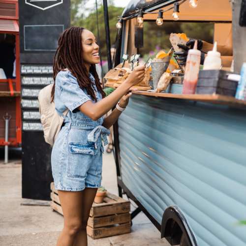 Woman picking up food truck order near Cherokee Summit Apartments in Acworth, Georgia