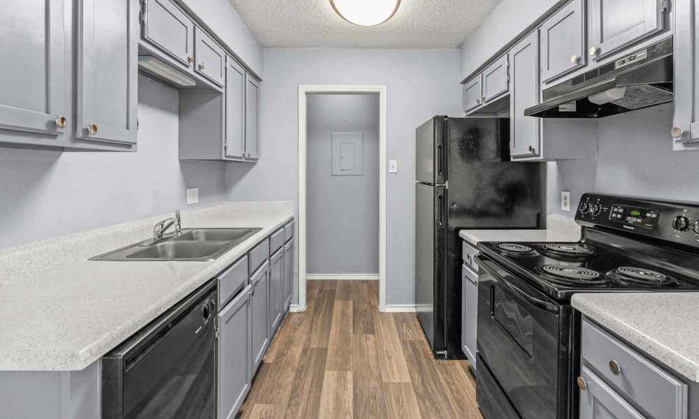 Kitchen with black appliances at North Hills Place in Richland Hills, Texas