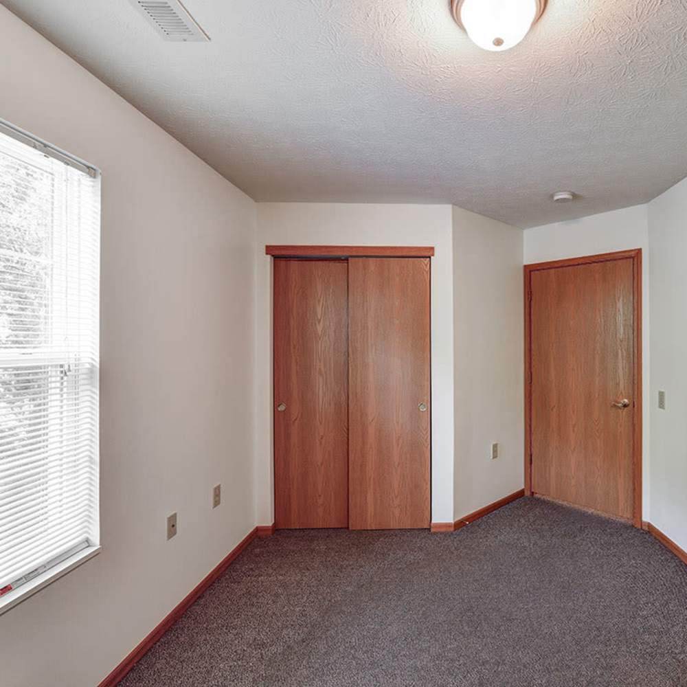 Carpeted floor with two wooden doors at Clover Ridge in McConnelsville, Ohio