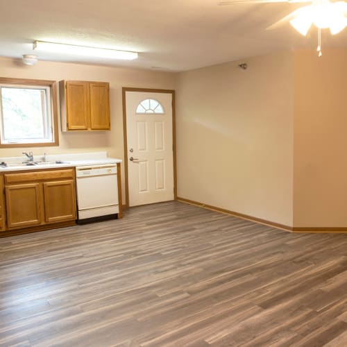 Kitchen and dining room with wood flooring at Stone Court in Ames, Iowa