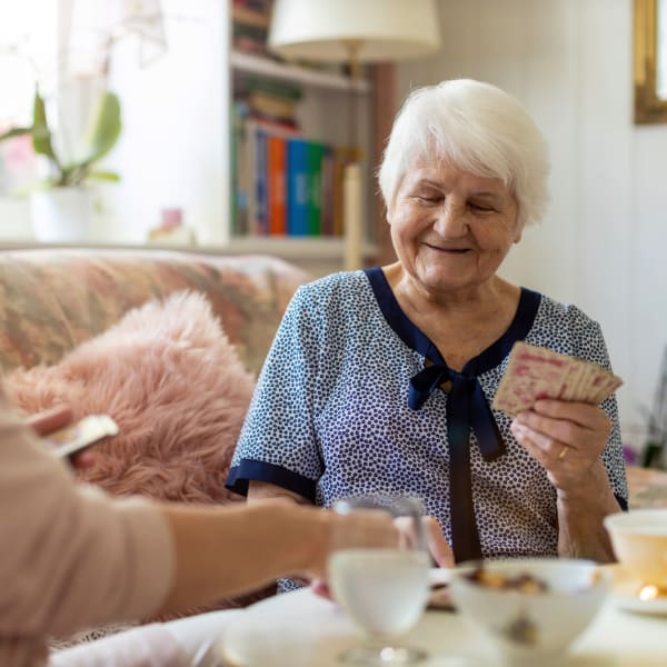 Two residents playing a card game at Pacifica Senior Living Escondido in Escondido, California.
