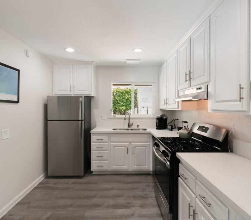 Bright kitchen with stainless steel appliances at The Heights at Grand Terrace in Grand Terrace, California