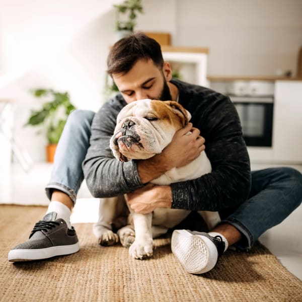 man cuddling his dog at American Property Management in Bellevue, Washington