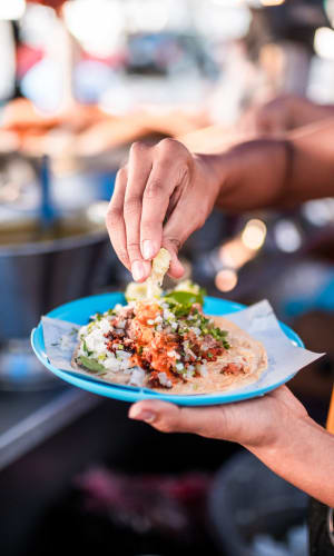 Resident enjoying tacos at a restaurant near Fisher Duplexes in Dallas, Texas