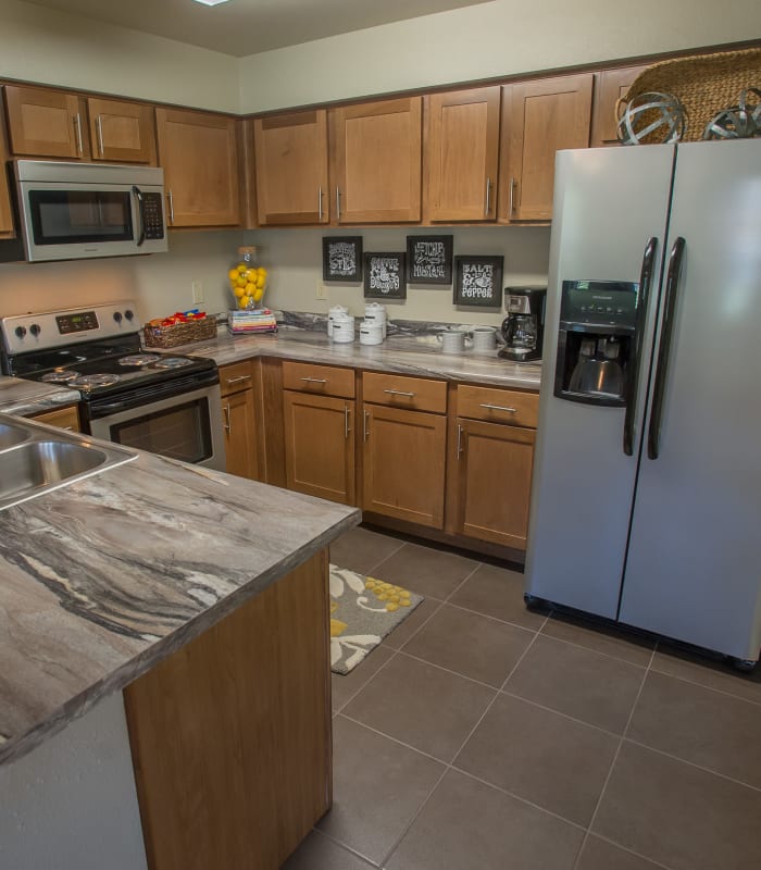 Kitchen with granite countertops at The Reserve at Elm in Jenks, Oklahoma