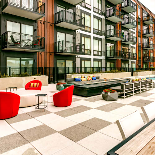 Seating around an outdoor firepit by the swimming pool at Junction Flats in Minneapolis, Minnesota