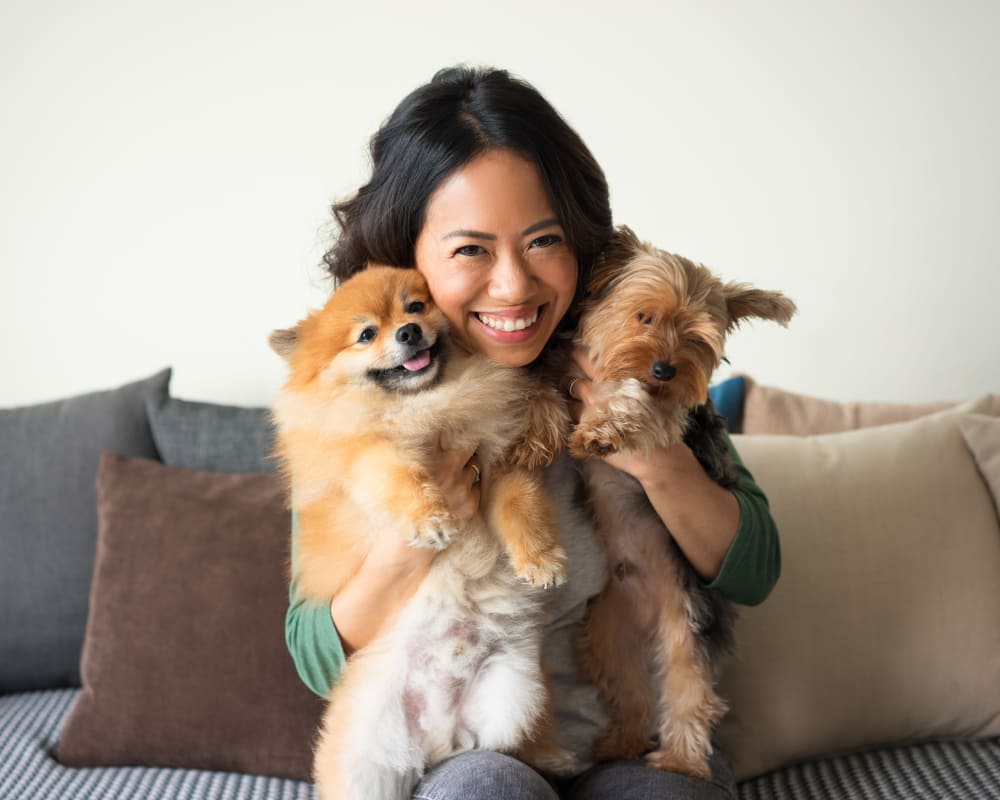 Resident hugging her dogs at Watermarke Apartments in Fort Worth, Texas