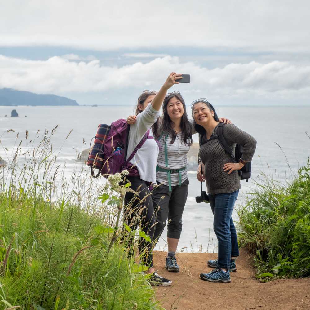 Three women taking a selfie outdoors at Dolphin Marina Apartments in Marina Del Rey, California