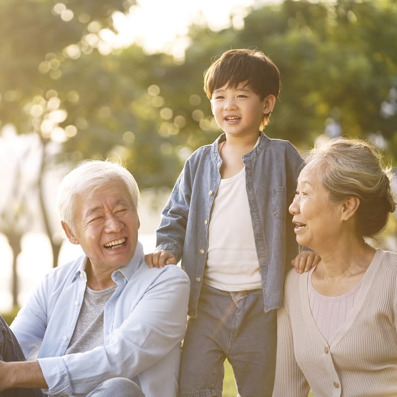 Resident couple sitting outside with their grandson at The Hearth at Franklin in Franklin, Tennessee