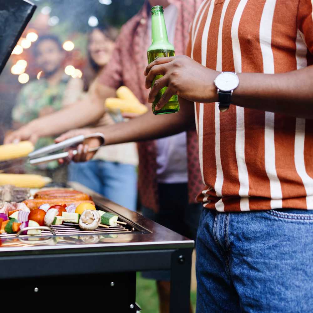Outdoor barbecue with friends, vibrant food on the grill at Antioch Family & Senior Apartments in Antioch, California
