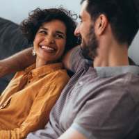 Couple sharing a laugh in their apartment home at Villas of Brighton in Rochester, New York