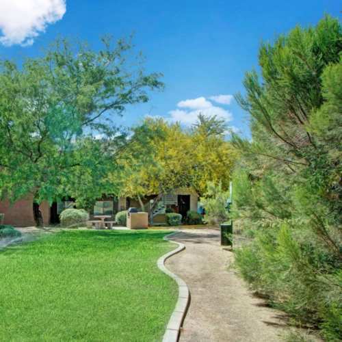 Beautifully landscaped courtyard with walking path at Tierra Vida in Tucson, Arizona