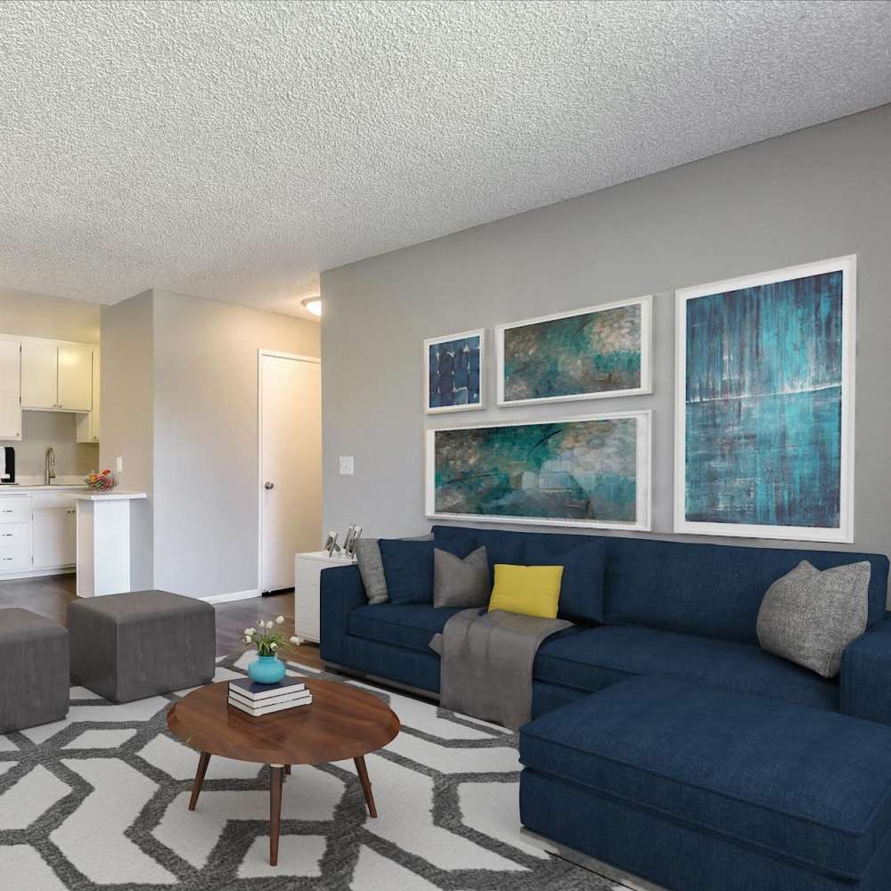 Spacious living room with wood-style flooring at Santa Teresa Apartments in San Jose, California,