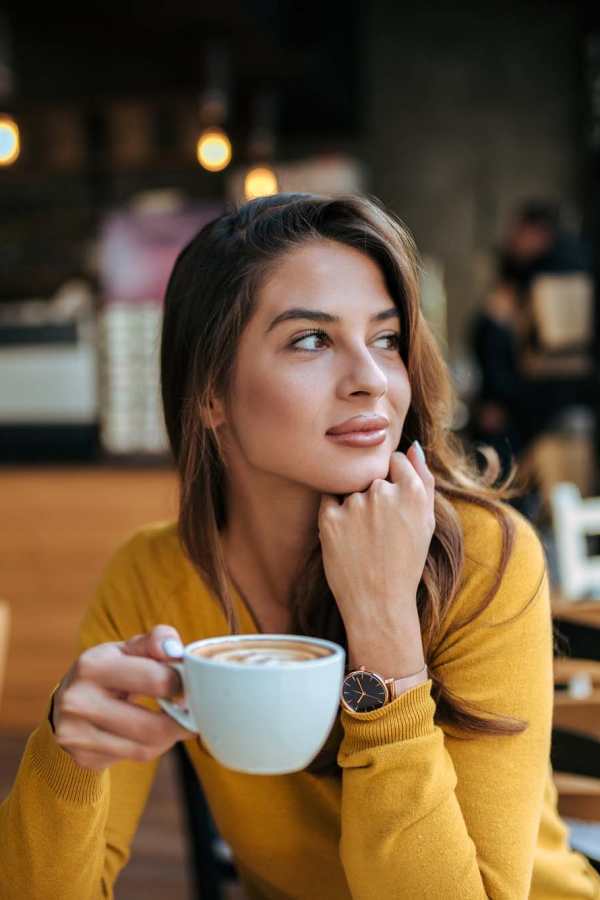 Resident enjoying a cup of coffee at a cafe near The Abbey at Medical Center in San Antonio, Texas