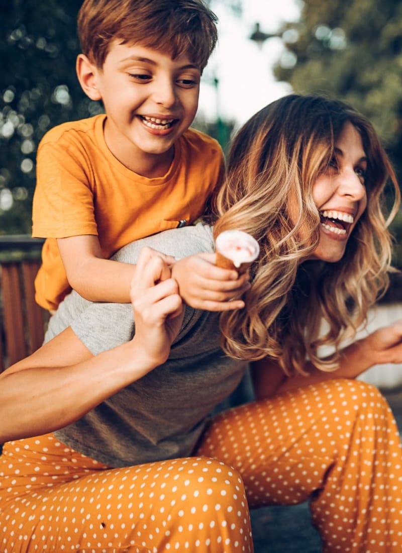 A resident and her son laughing near Marquis Ellis Crossing in Durham, North Carolina