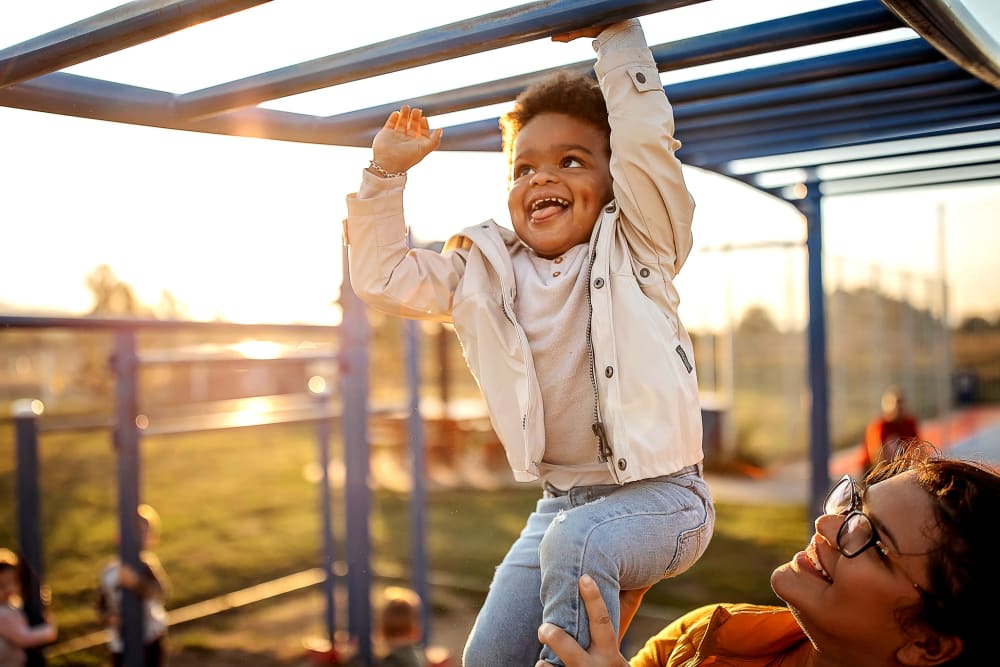 Mom and son playing on playground at The Everstead at Madison in Madison, Alabama