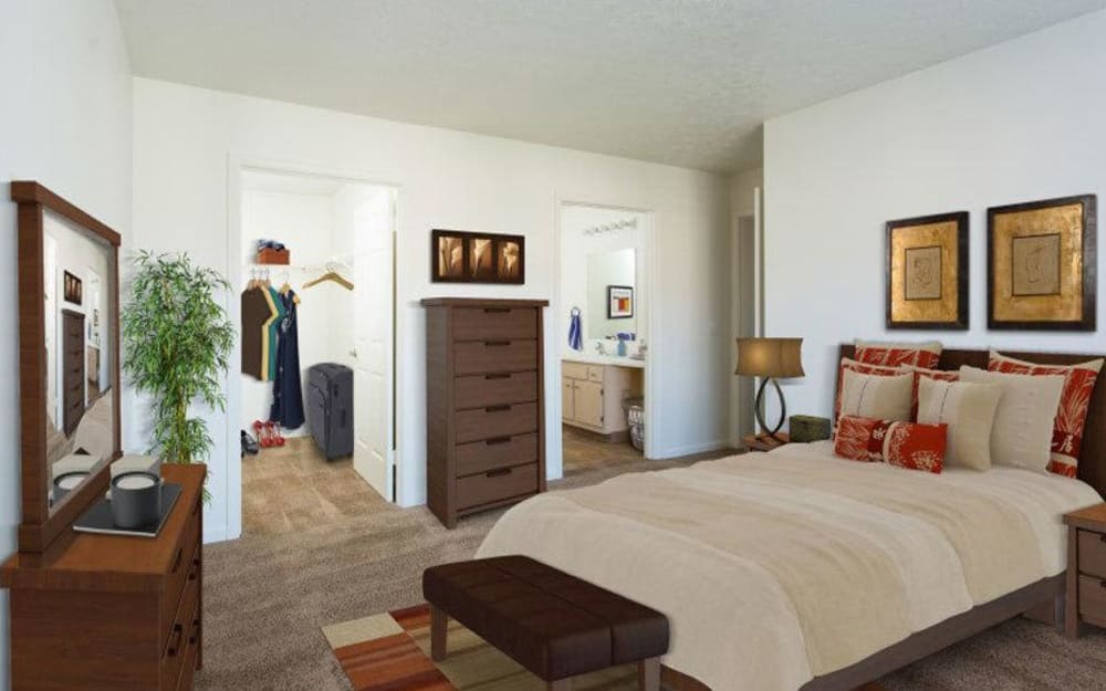 Model bedroom with ensuite bathroom and walk-in closet at Westview Commons Apartments in Rochester, New York