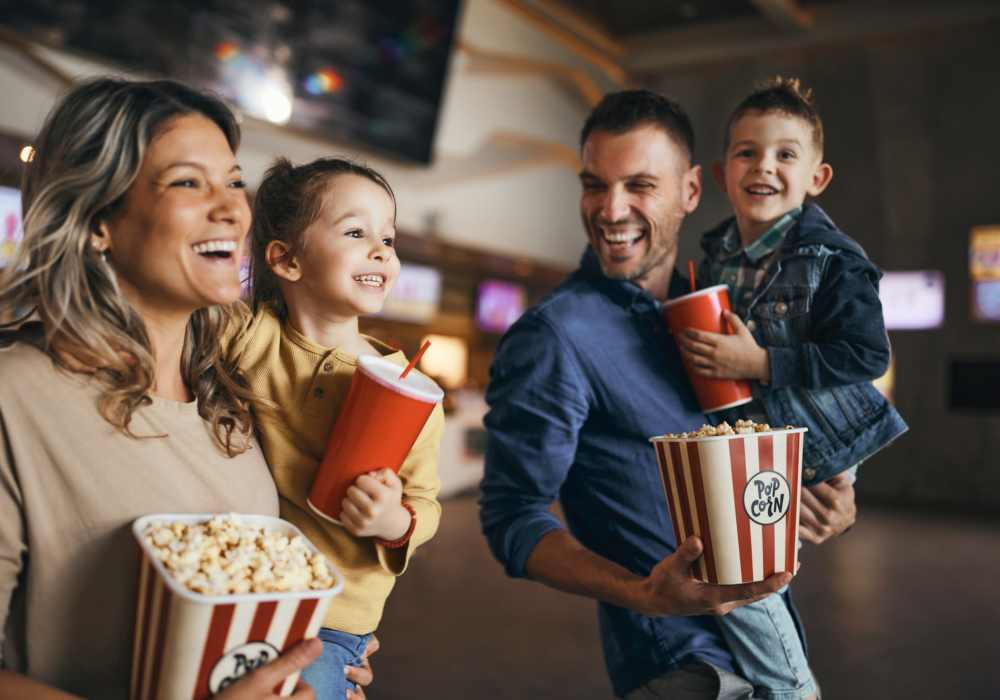 Brightly lit movie theater interior with families near Botanica in Mandeville, Louisiana