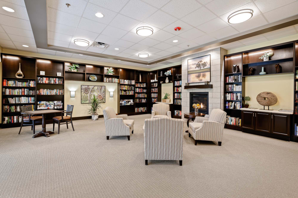 Elegant sitting area with bookcases at Anthology of Olathe in Olathe, Kansas