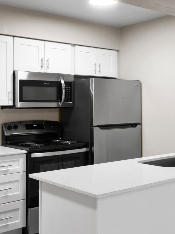 Fully-equipped kitchen with stainless steel appliances and marble countertop at Sono Tempe in Tempe, Arizona