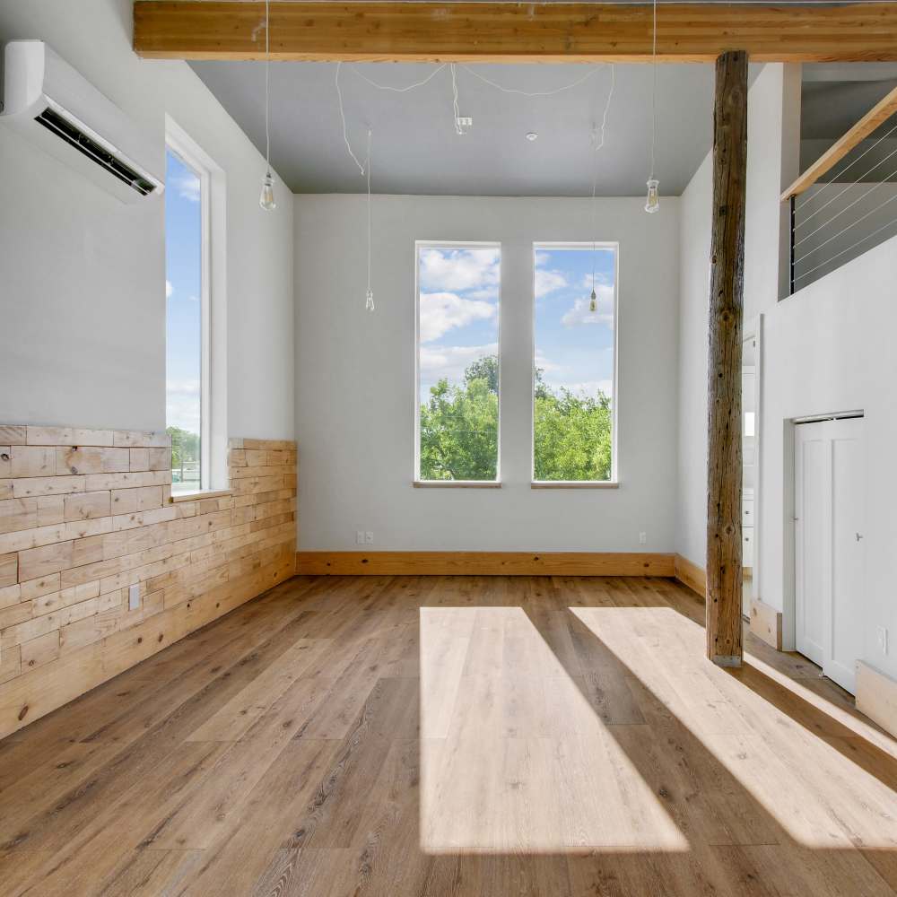 Unfurnished living room with large windows at The Lofts at 305 in Bryan, Texas