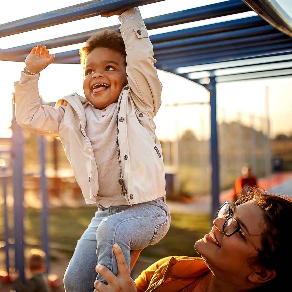 Child playing on playground equipment during golden hour at Antioch Family & Senior Apartments in Antioch, California