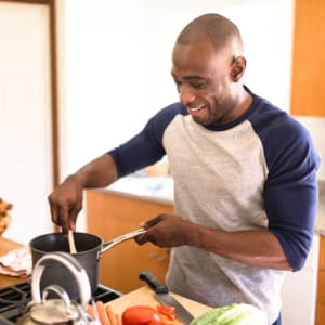 Resident cooking in his new kitchen at Estancia Hills in Dallas, Texas