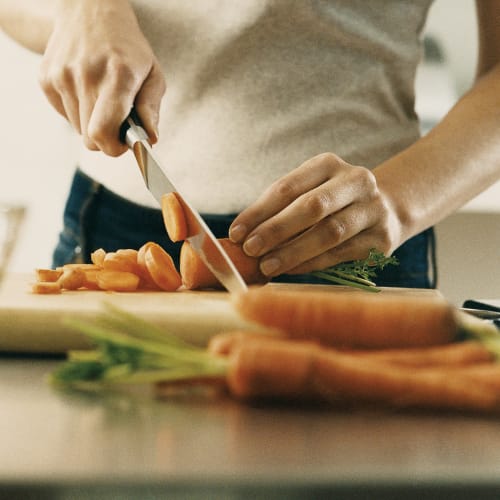 Chopping carrots in a kitchen at Mission University Pines in Durham, North Carolina