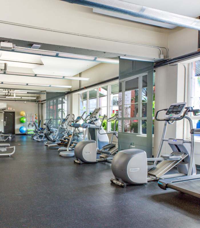 Resident working out in the gym at American Can Apartments in New Orleans, Louisiana