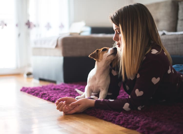 Resident playing with her dog at Cambridge Place in Houston, Texas.