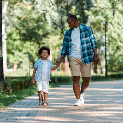 Father walking with son in the park in Haltom City, Texas near Bellrock Upper North