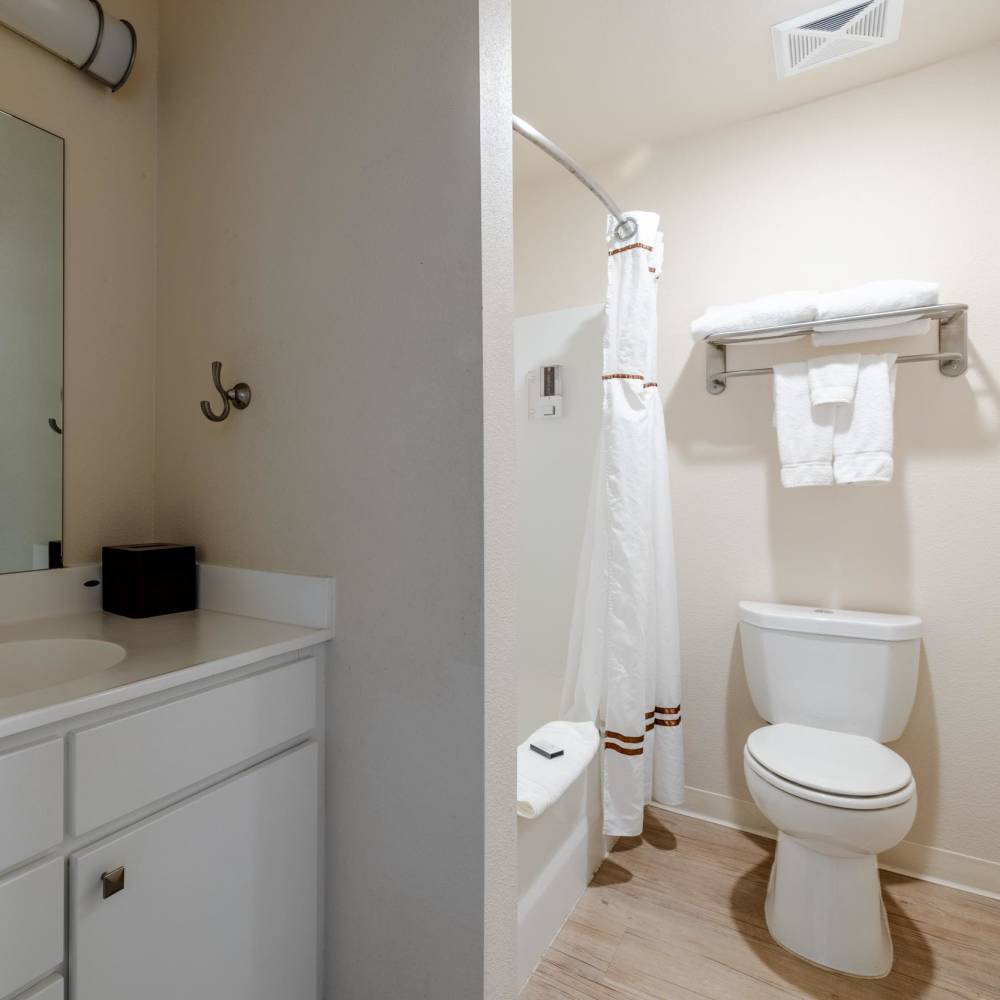 Bathroom with vanity outside and commode,bathtub inside at WaterWalk Wichita - Downtown in Wichita, Kansas