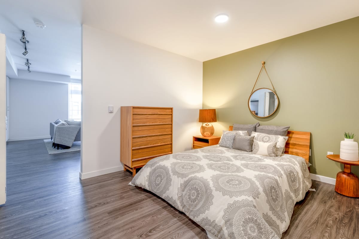 Apartment bedroom with wood-style flooring at Circa Greenlake in Seattle, Washington