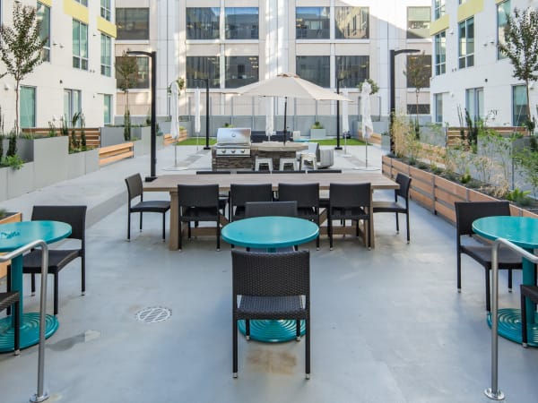 Barbecue area with gas grills in the interior open-air courtyard at EVIVA Midtown in Sacramento, California