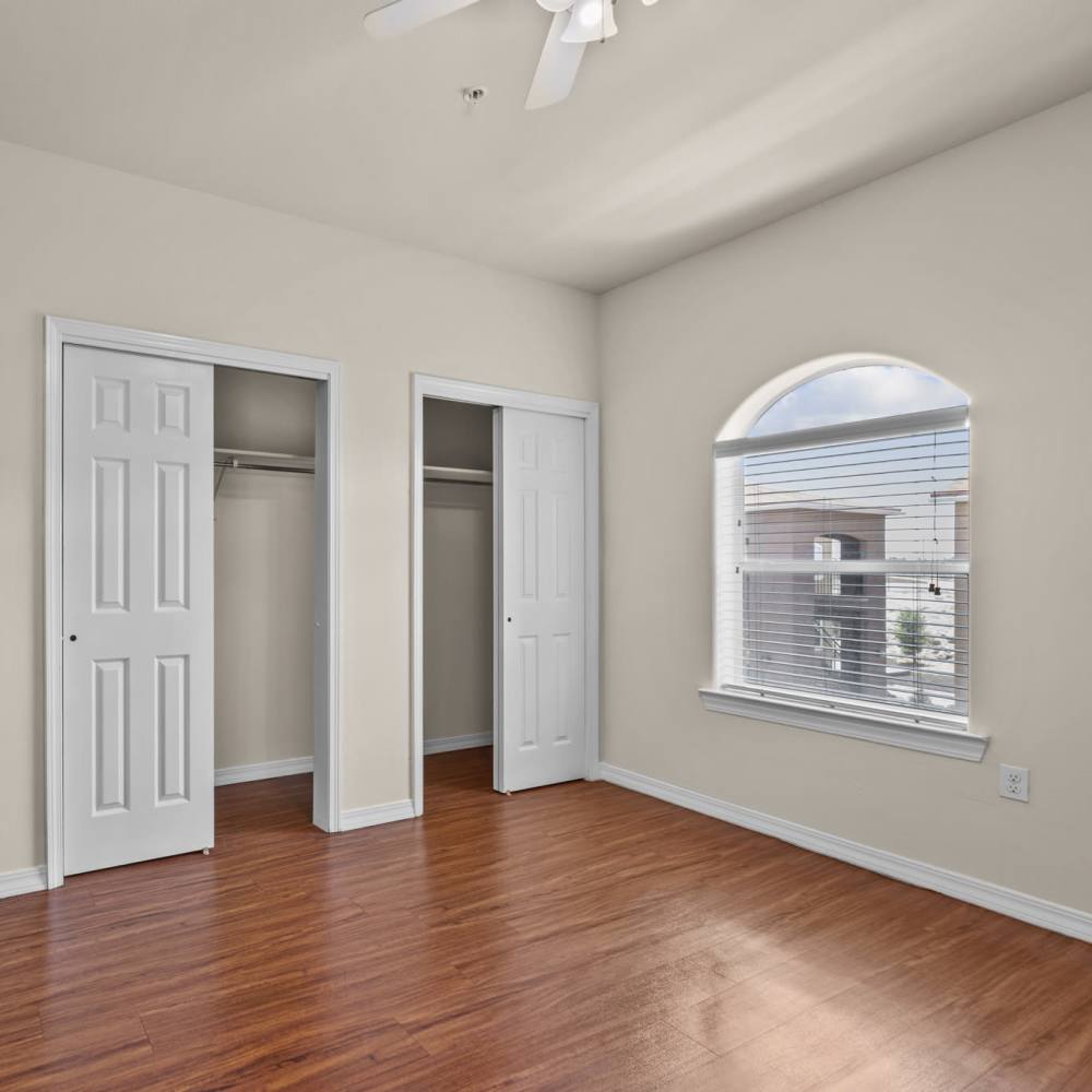 Well-lit modern bedroom with closet space at Las Torres Apartments in El Paso, Texas