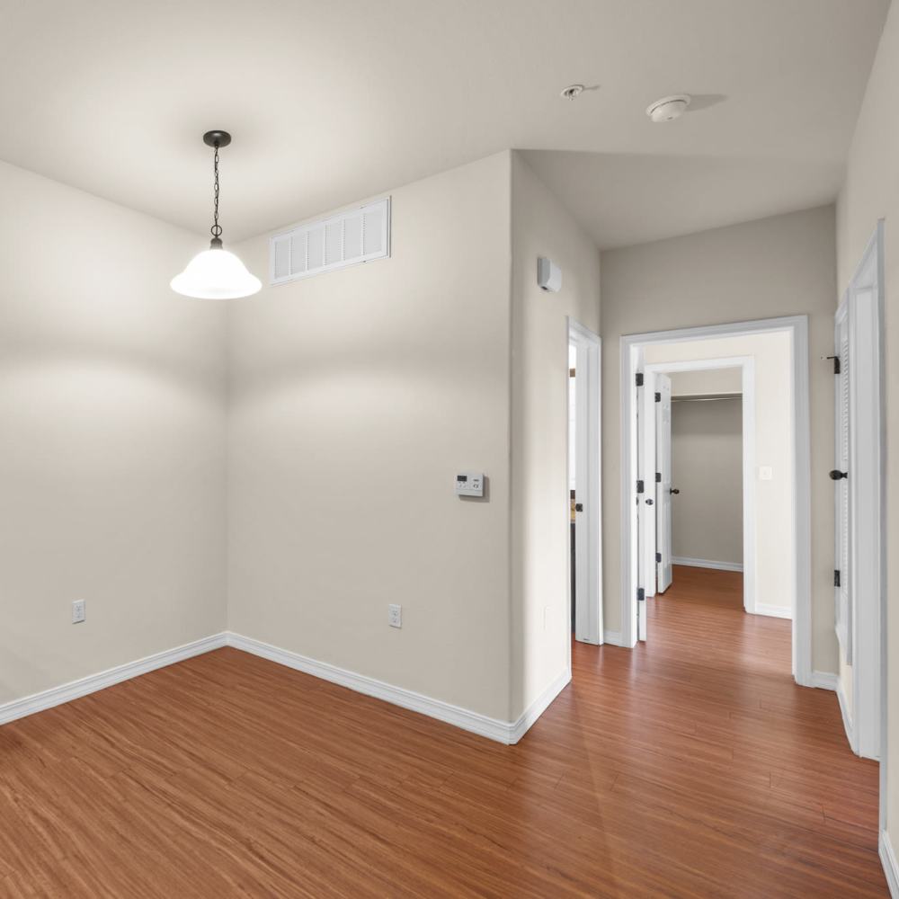 Hall way with wood-style flooring at Las Torres Apartments in El Paso, Texas