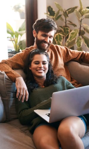 Couple catching up on a series on their laptop at Crystal Ridge in Midlothian, Texas