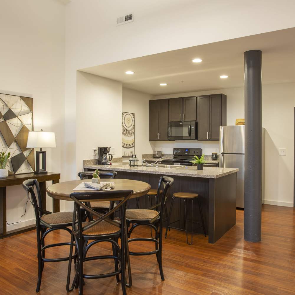 Dining area and kitchen with modern appliances at Lofts at Inman Mills in Inman, South Carolina