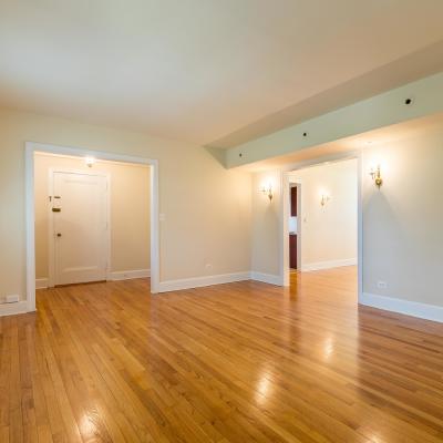 A spacious room with wood flooring in a home at Perry Circle Apartments in Annapolis, Maryland
