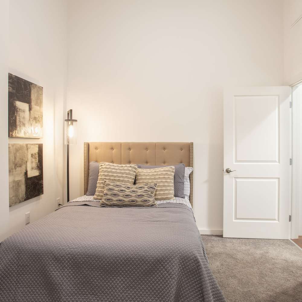 Bedroom with cozy bed at Lofts at Inman Mills in Inman, South Carolina