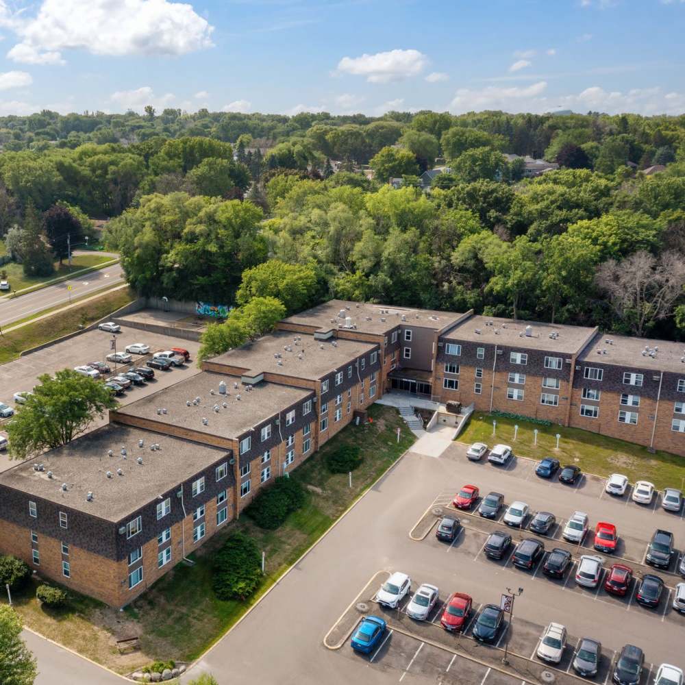 View of the apartments with car parking at Shamrock Court Apartments in Saint Paul, Minnesota