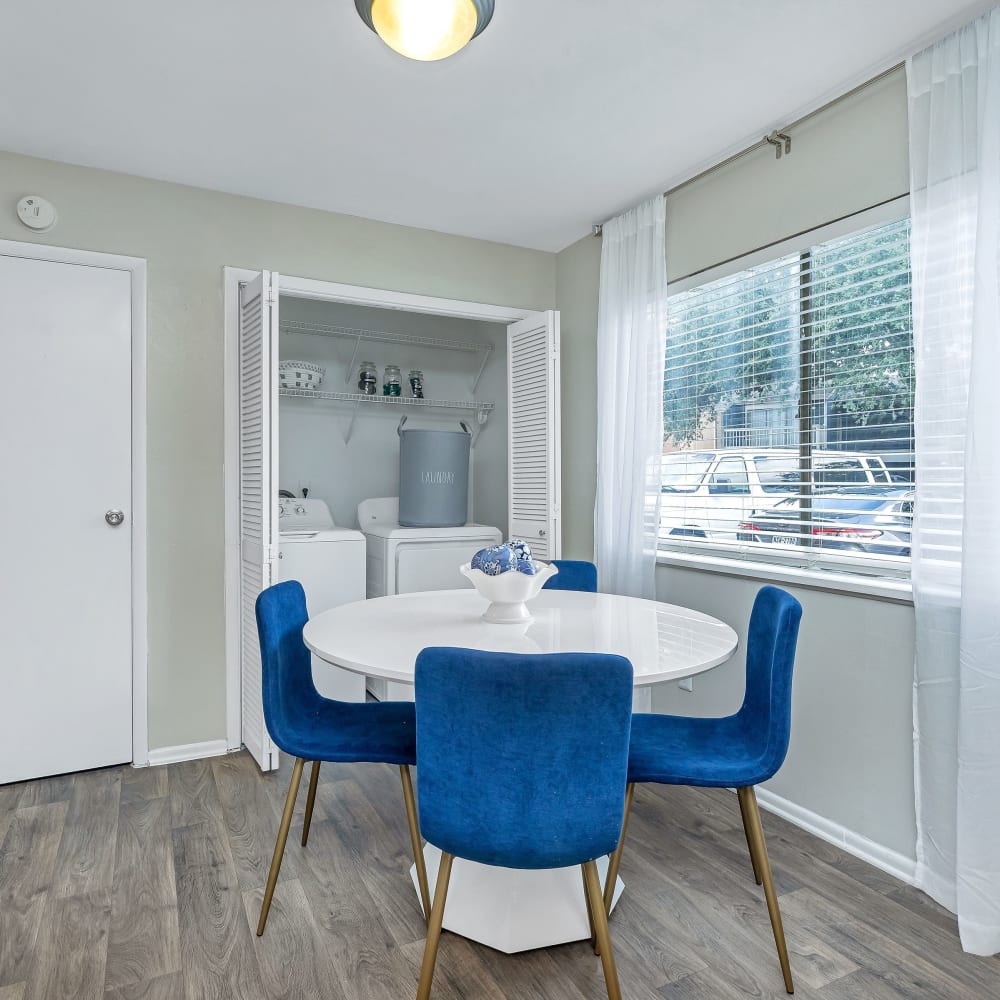 A dining room with wood-style flooring at Barringer Square in Webster, Texas